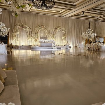 Elegant wedding reception setup with floral decorations.