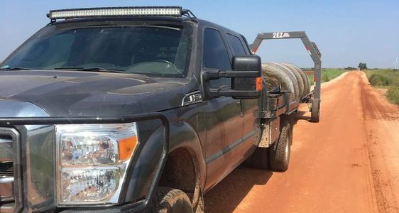 THE 2EZ BALE MOVER HAULING HAY GATHERED FROM HAY FIELD.