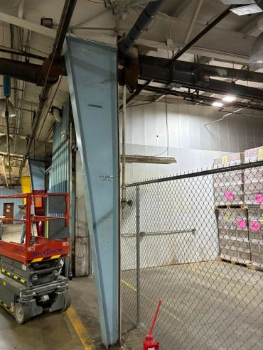 Welding team replacing a damaged structural steel column on-site
