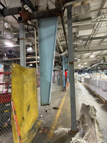 Welding team replacing a damaged structural steel column on-site