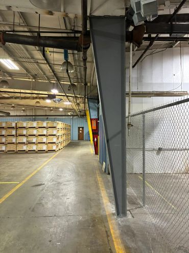 Welding team replacing a damaged structural steel column on-site