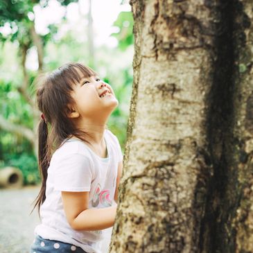 Girl hugging a tree