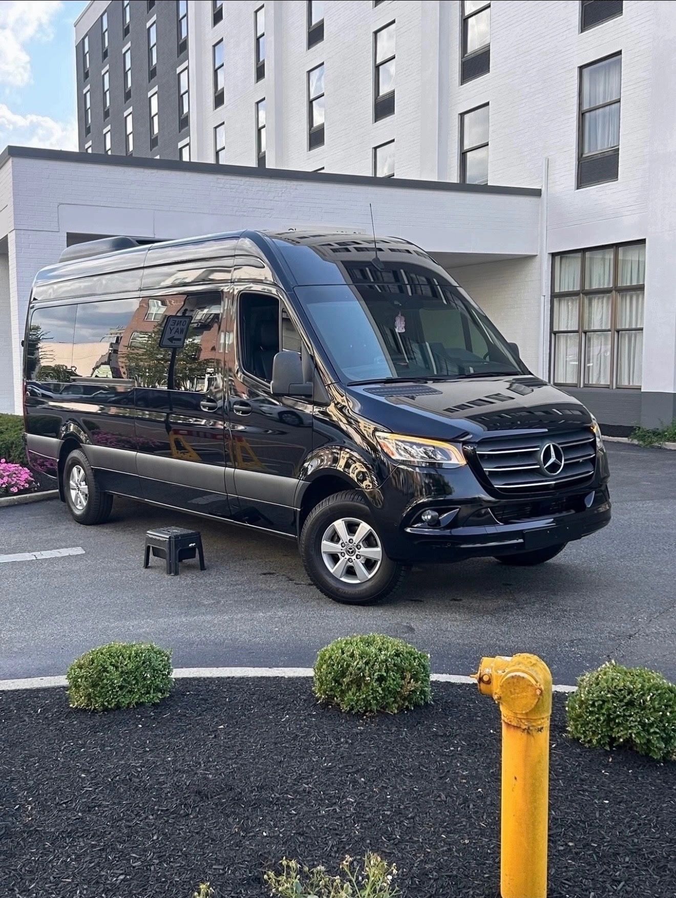 Black Mercedes-Benz van parked near a building.