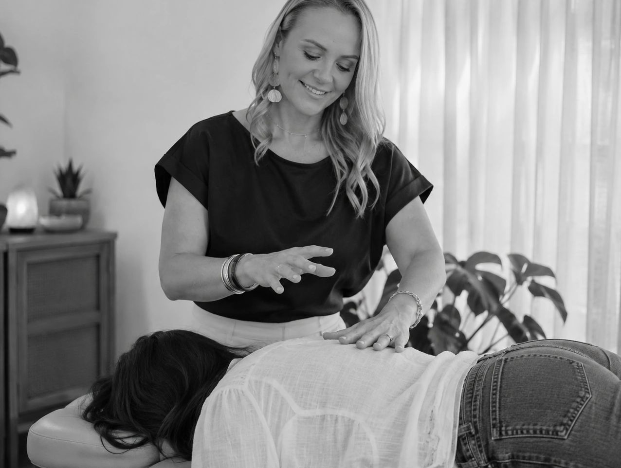 Woman receiving a healing session from a practitioner.