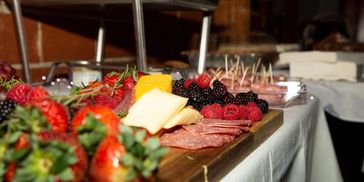 Charcuterie board featuring fresh strawberries, blackberries