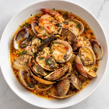 Garlic butter clams and shrimp in a rich Creole seafood broth