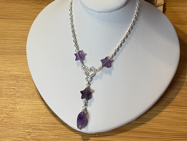 Amethyst star and oval pendant jewelry set with earrings and necklace.