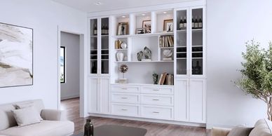 Modern living room with white cabinetry, neutral sofas, and wooden flooring.