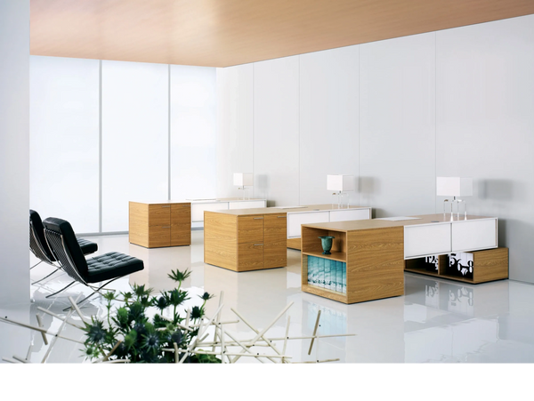 In2design's desking systems, in white space with black Knoll Barcelona Mies van der Rohe chairs