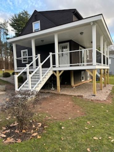 Black house with white deck