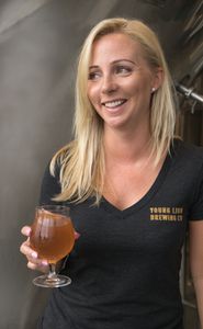 Alicia Wolk, Founder (headshot of her holding a beer)