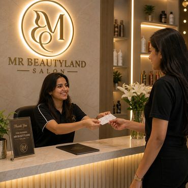 Receptionist smiling while handing a card to a customer at MR BEAUTYLAND SALON.