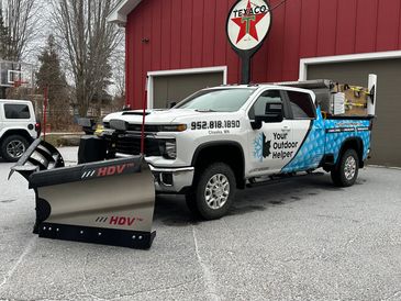 Picture of Your Outdoor Helper LLC's Snowplowing truck with snow shovels on the walls of the dumpbed