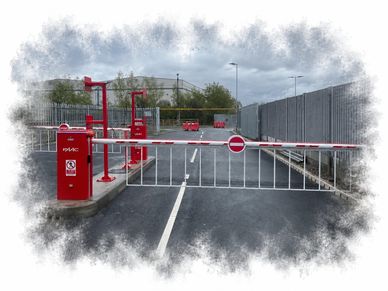 A red and white barrier gate blocks a road with no entry signs.