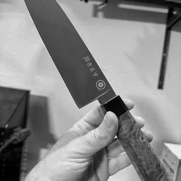Hand holding a Japanese kitchen knife.