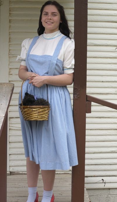 Dorothy stands on the porch of Dorothy's House