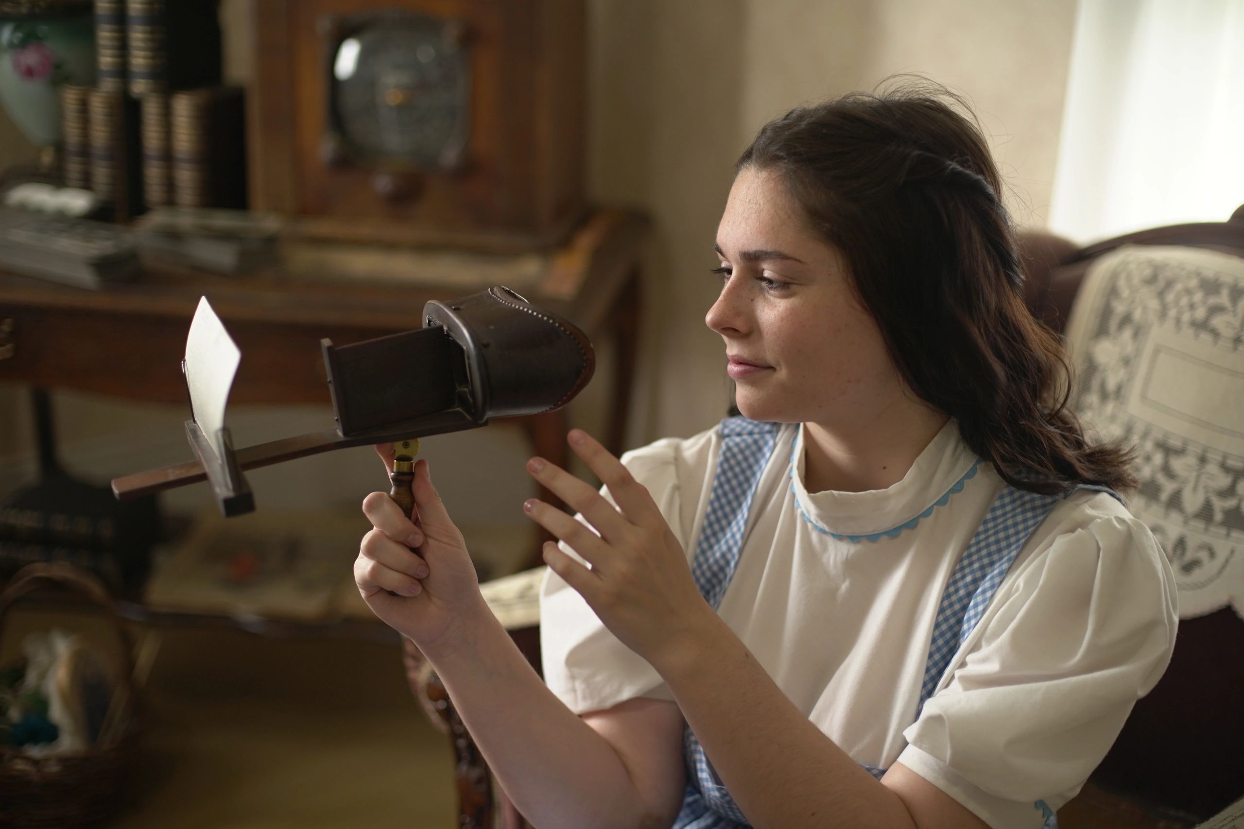 A Dorothy tour guide shows off an antique stereoscope inside Dorothy's House