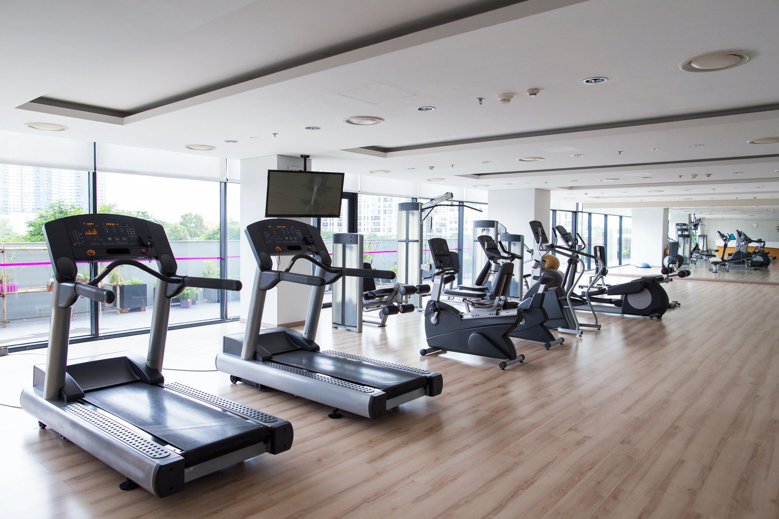Bright and spacious gym with modern treadmills and exercise bikes.