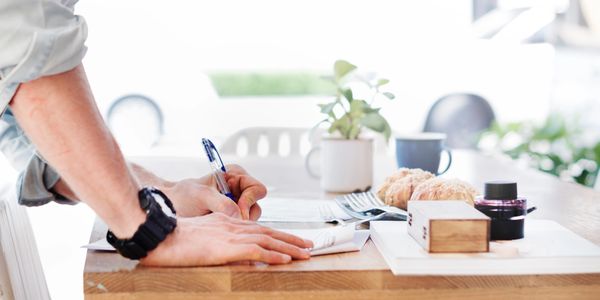 man working on business tasks - leaned over desk