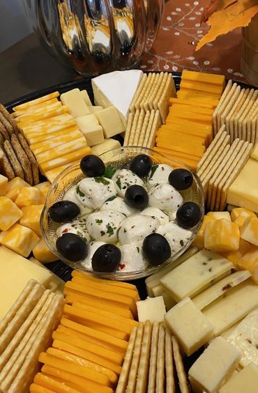 Cheese and cracker tray with fresh mozzarella and black olives
