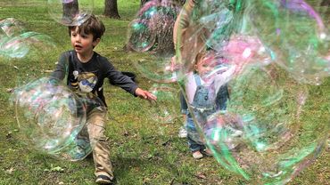 Children pop GIANT bubbles. Grandpop Bubbles entertains crowds at "Free Bubble Festivals."