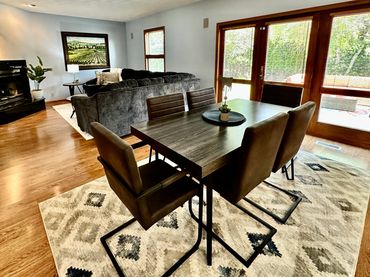 large dining and living room of a vacation rental in Janesville, WI decorated by the MDR Design Team