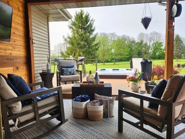 View from dining room to new covered porch and hot tub area, outdoor remodel by MDR Design Co in Edg