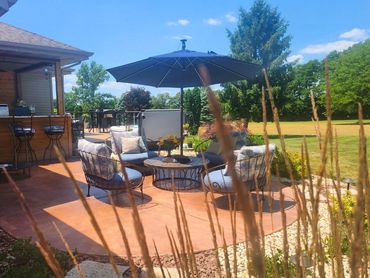 View overlooking newly expanded outdoor kitchen and deck in Edgerton, WI by MDR Design Co.
