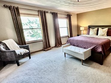 Primary bedroom of a vacation rental in Janesville, WI decorated by the MDR Design Team