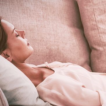 A woman receiving gentle guidance through a hypnosis session