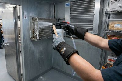Proactive Care: A technician performs a deep-coil clean to ensure peak efficiency and avoid breakdow