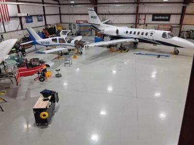 Planes and a jet in a hangar