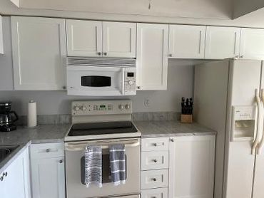 Bright kitchen with white granite countertops