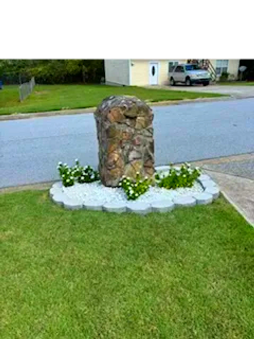 Planting bed with white rocks and flowers