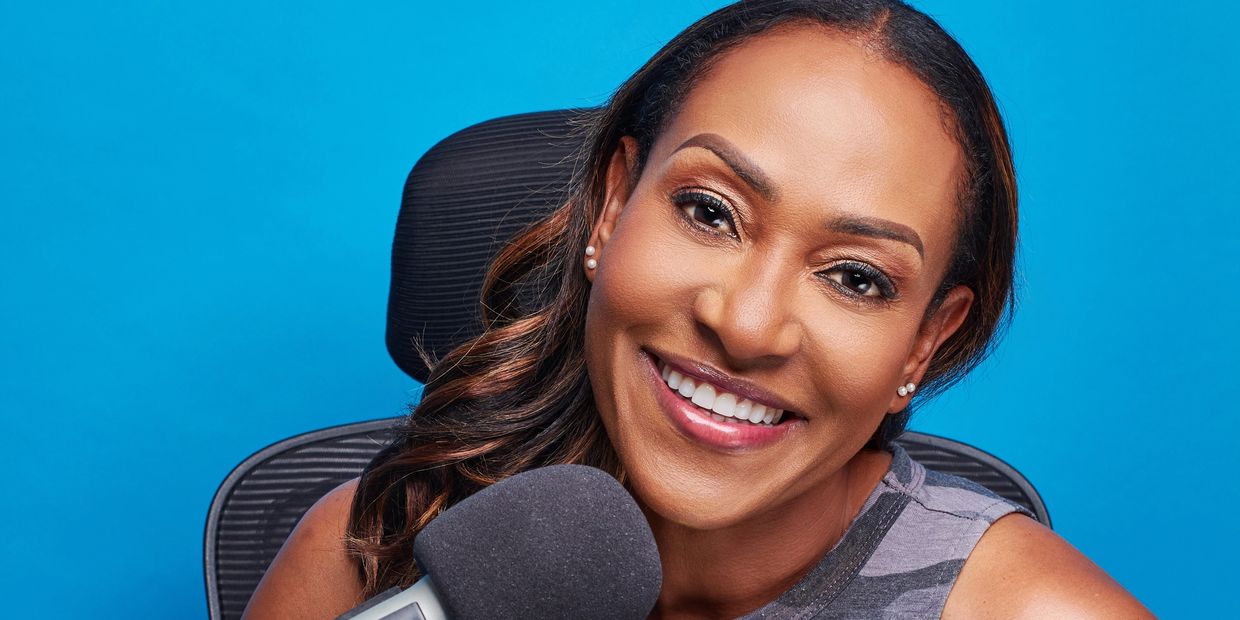 Interview Coach Allison Watson, smiling, speaking on a podcast, in an interview/ interview training