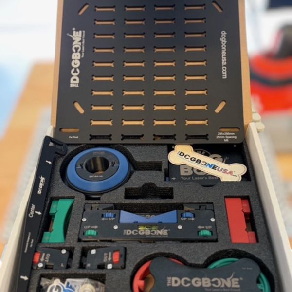 A DCGBONE laser alignment tool kit with various components.