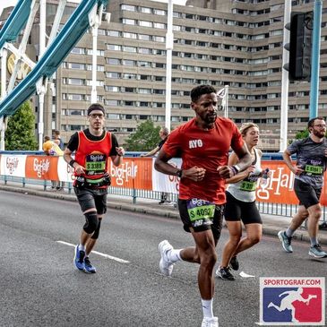Runners participating in a marathon on Tower Bridge in London.