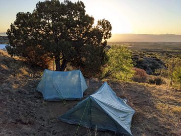 Ultralight backpacking tents in the mountains at sunset.