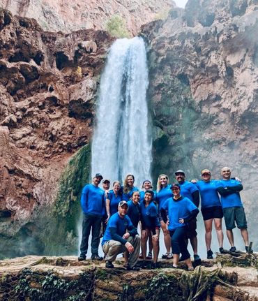 A large group of people on a hike in Havasupai below Mooney Falls.