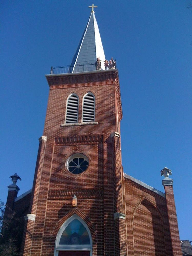The front of St. John's Lutheran Church with greeters waving from the steeple