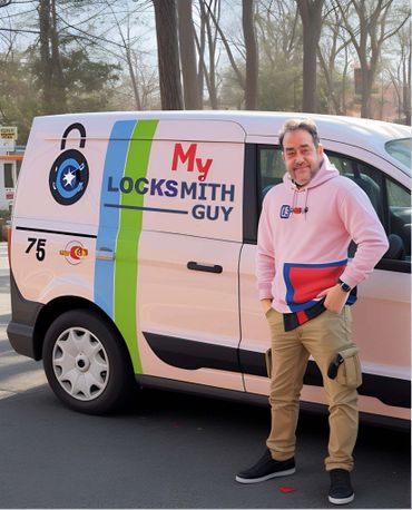 A locksmith standing next to his branded service van outdoors.
