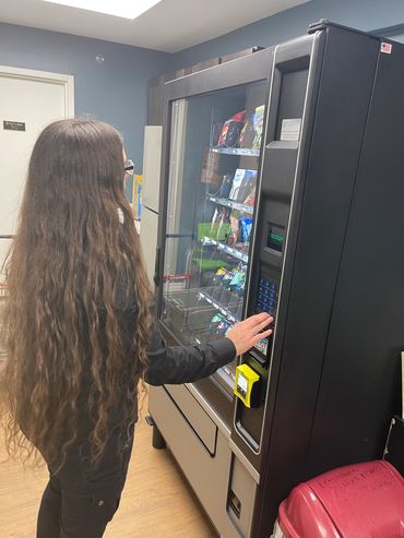 Woman at combo vending machine.