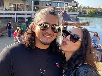 Couple smiling for the Roaming Photo Booth.