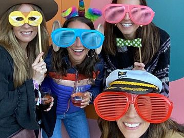 Image of four young ladies taking a photo with the Selfie Booth.