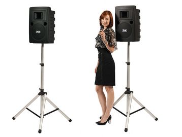 Two Anchor Audio battery-powered speakers on top of two speaker stands.