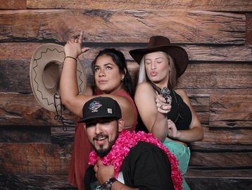 People posing as cowboys & cowgirls for the photo booth.
