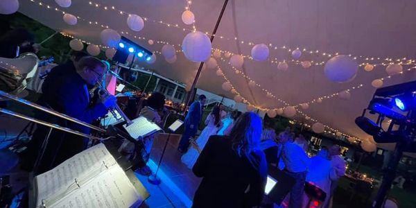 wedding band playing an outdoor reception with dancing