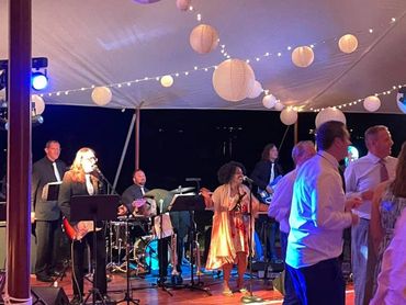 wedding band playing at an outdoor wedding reception
