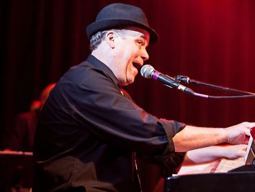 male vocalist at the piano and singing