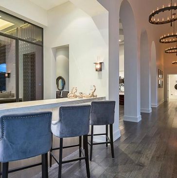 Modern bar seating area with blue chairs and stylish lighting.